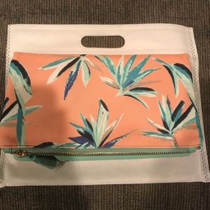 Reversible mint green & coral patterned clutch